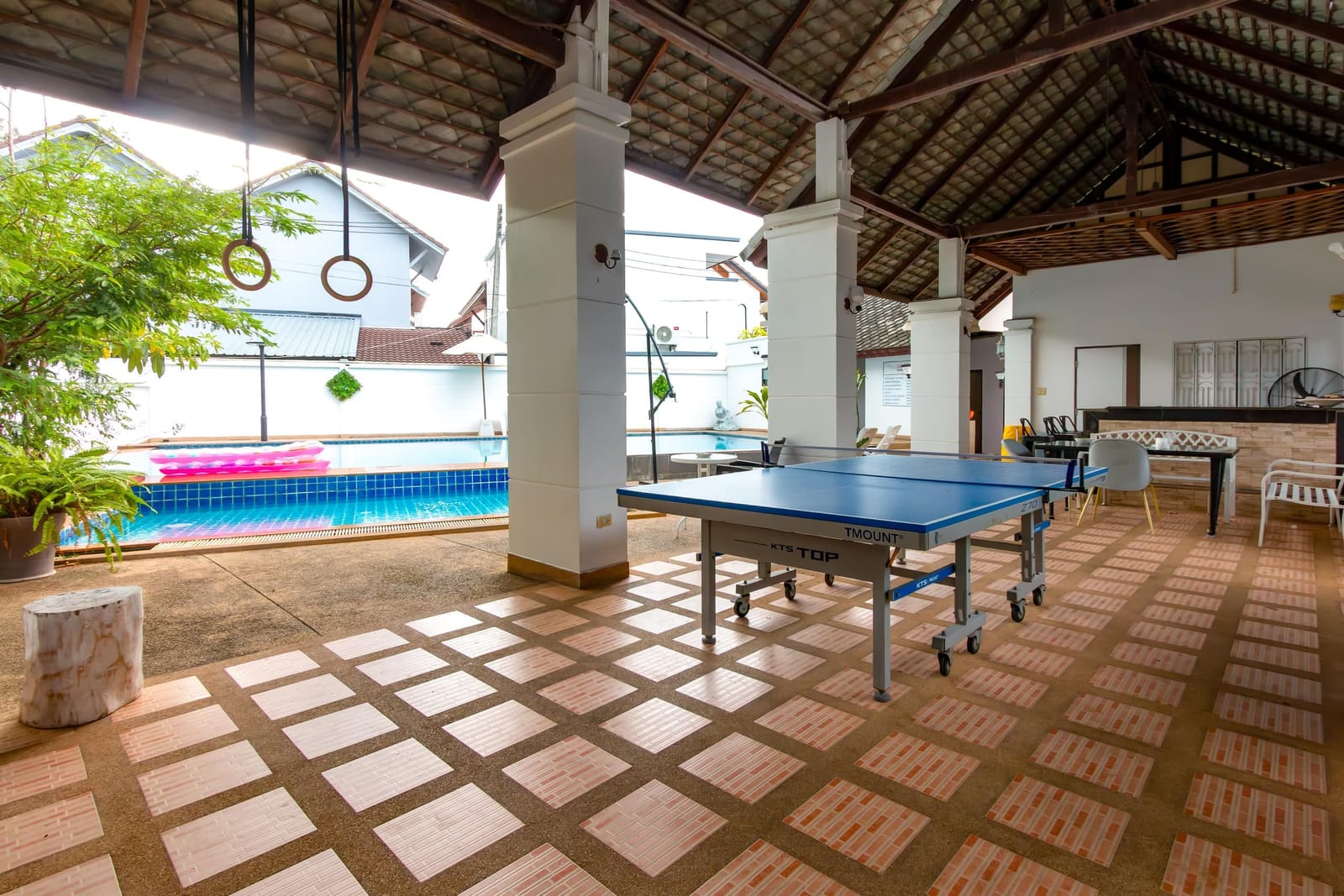 Covered pavilion with ping-pong beside the shared pool