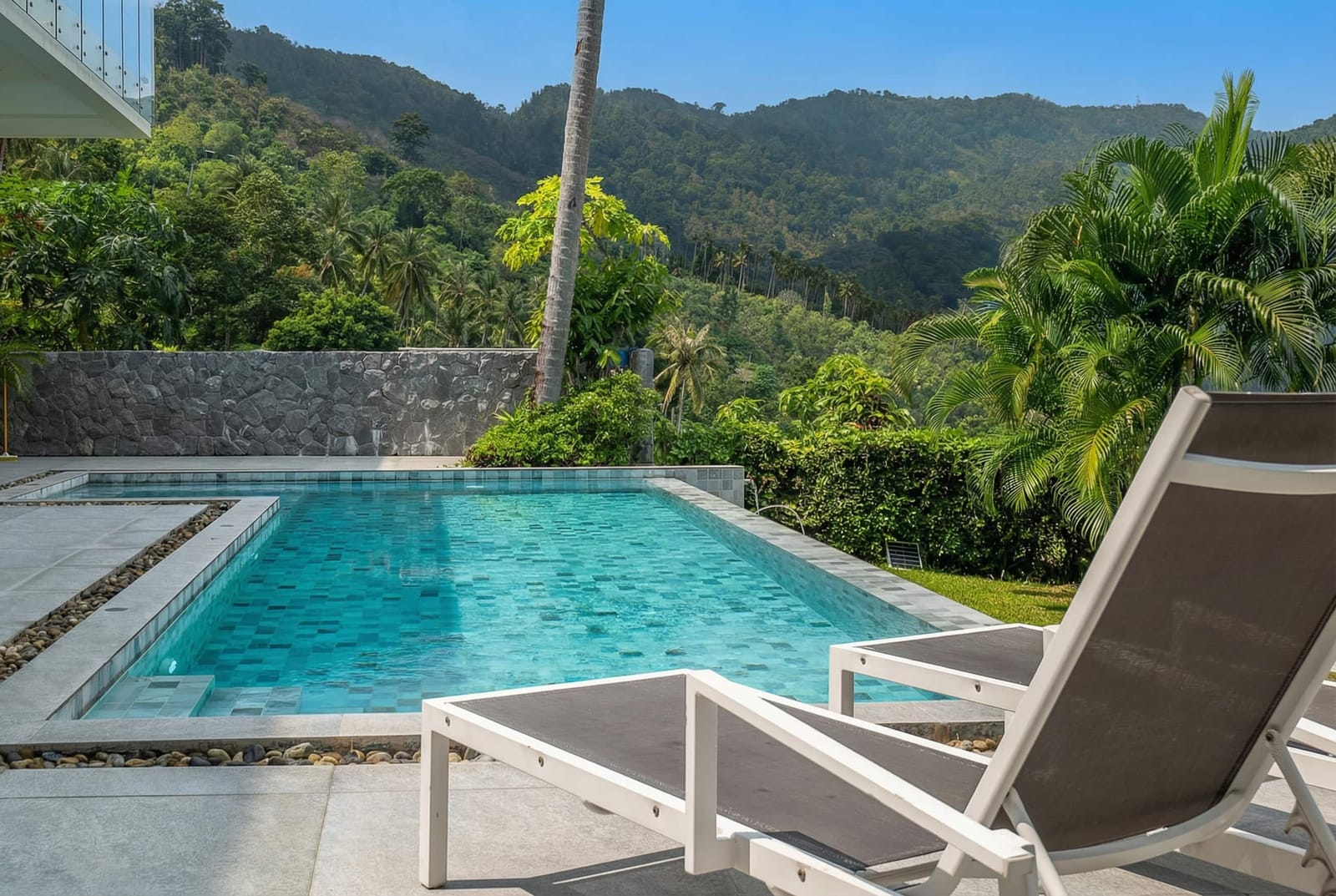 Sun loungers beside the pool at Villa Passiflore