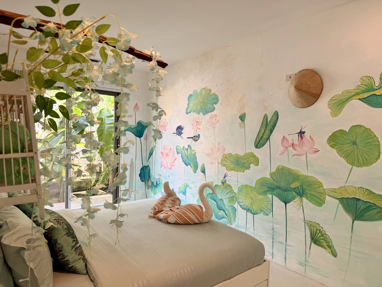 Bedroom with a painted lotus mural at Villa Samui Cao