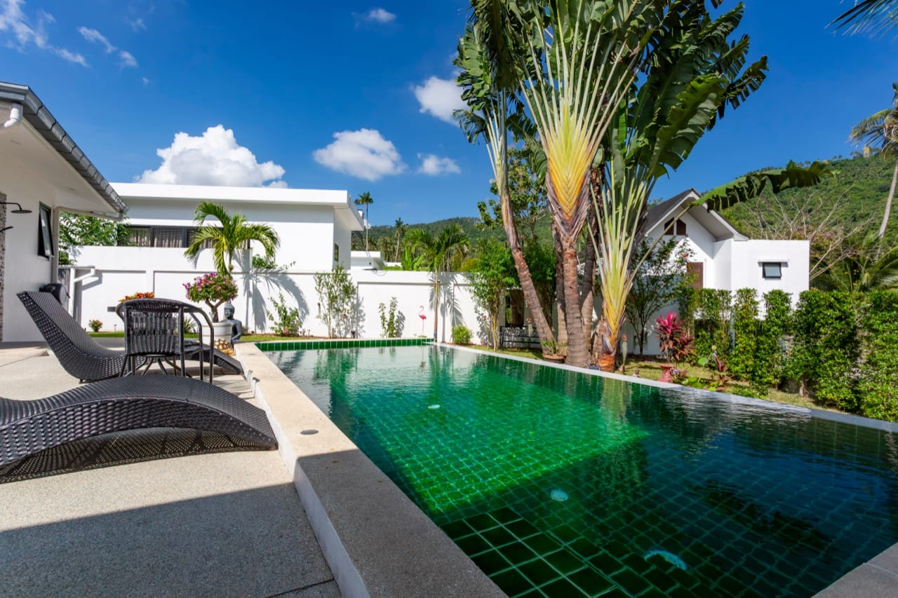 สระว่ายน้ำและระเบียงของ Villa International ในเวลากลางวัน